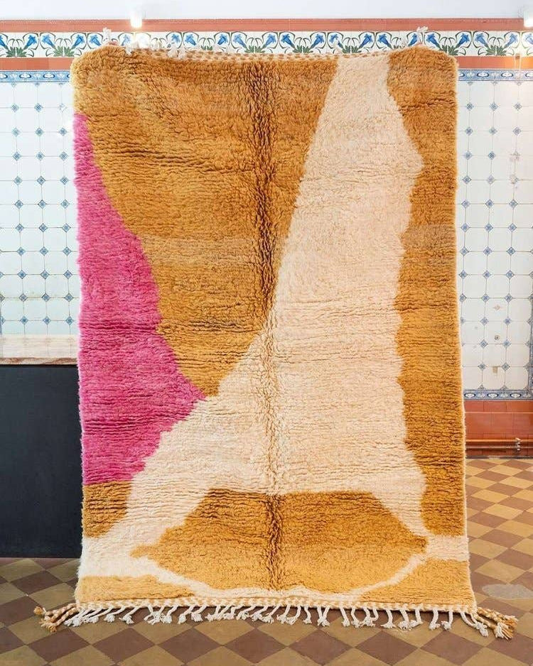 Multicolored textured rug with geometric pattern on a checkered floor.