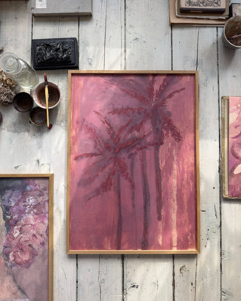 Framed abstract artwork on a rustic wooden wall with other decorative items.