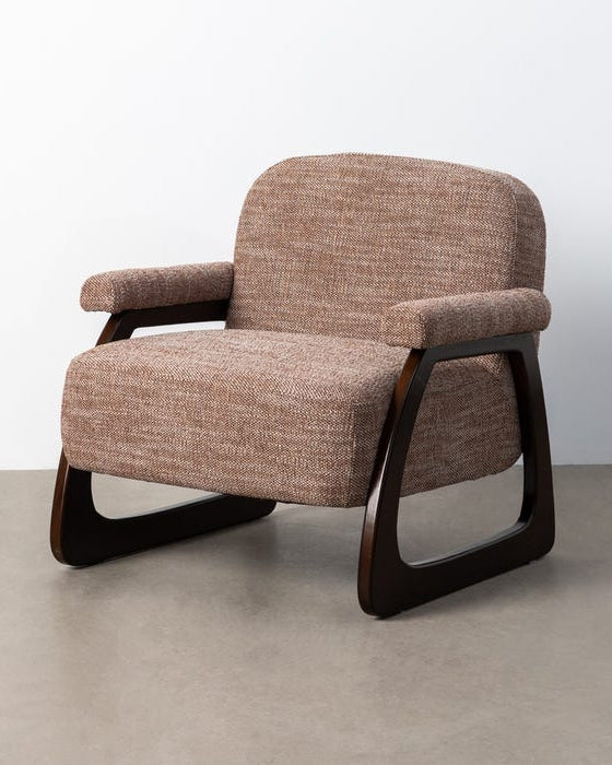 Brown upholstered armchair with wooden legs on a plain background