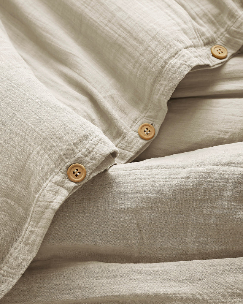 Close-up of beige fabric with buttons on a soft focus background